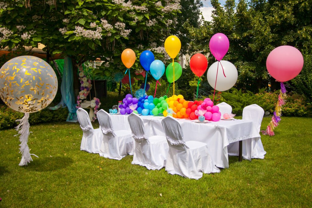 Birthday party table decorated with colorful balloons