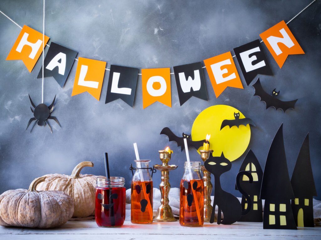Halloween party table decorated with carved pumpkins and candles for a Saturday night Halloween party