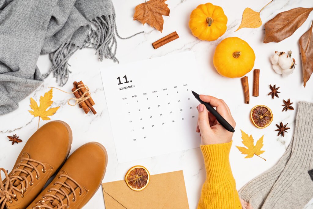 Flat lay of a November desk calendar with fall accessories, representing a no-spend November budget challenge