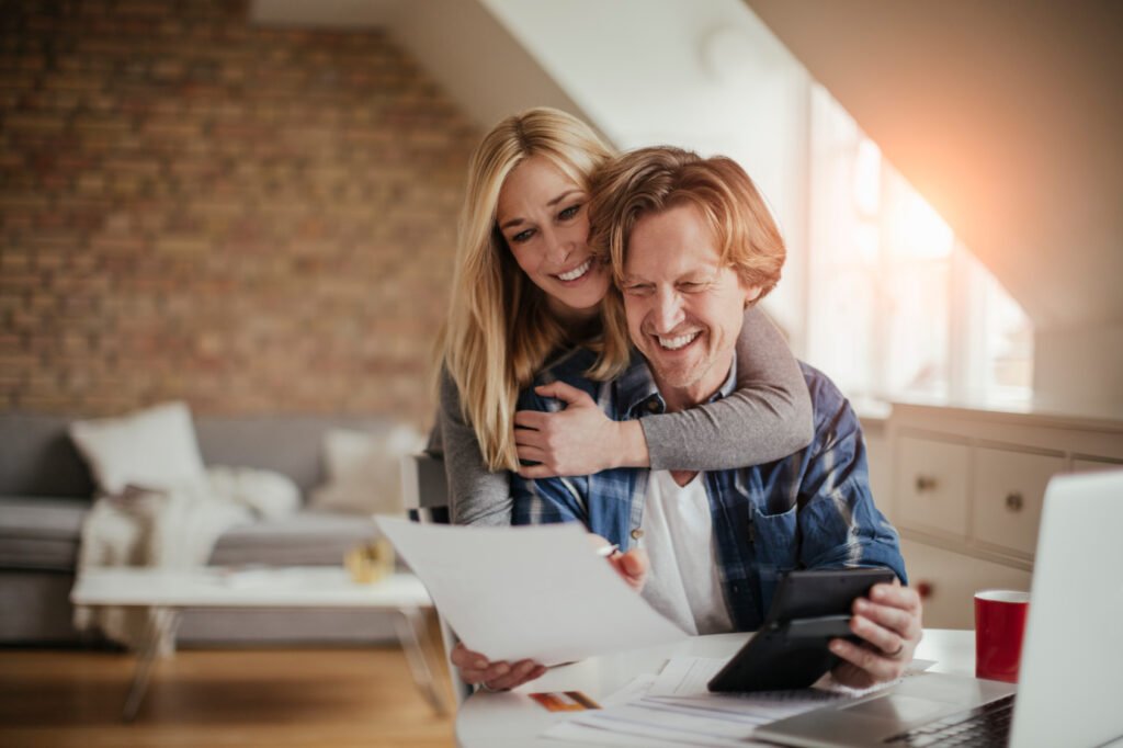 Couple reviewing their mortgage and household budget together at home